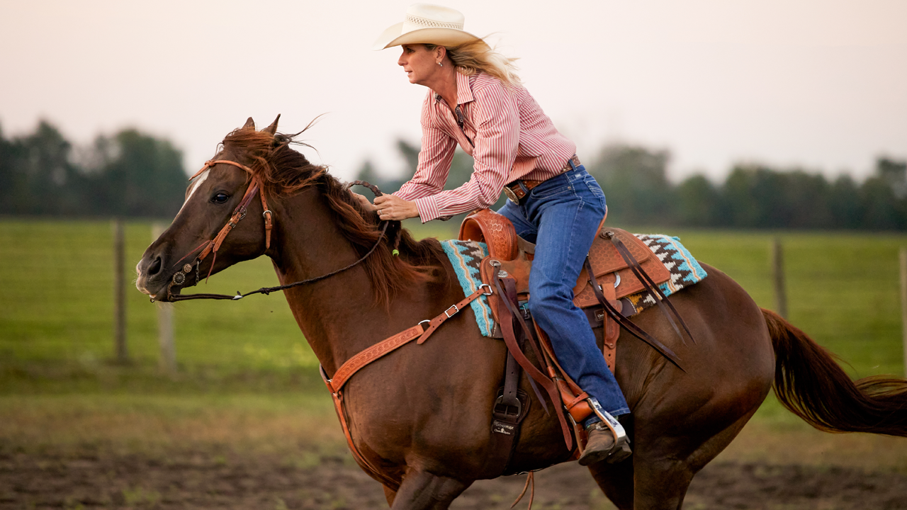 WPRA barrel racer Sherry Cervi practicing barrels on her horse.